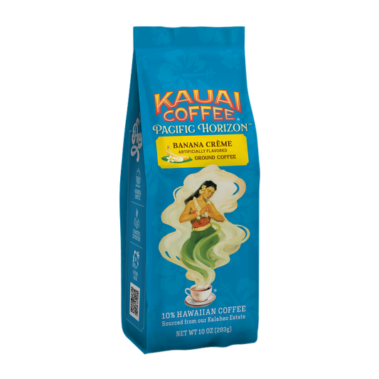 A blue bag of Kauai Coffees Banana Crème Flavor Ground Coffee features a traditional woman illustration with swirling green and white patterns. It highlights 10% Hawaiian harvested coffee and has a net weight of 10 oz (283g).